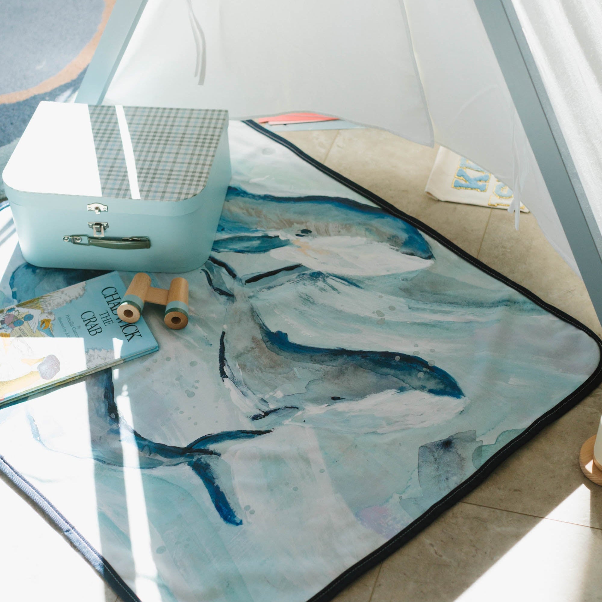 Baby blanket with whale design in a children's playroom
