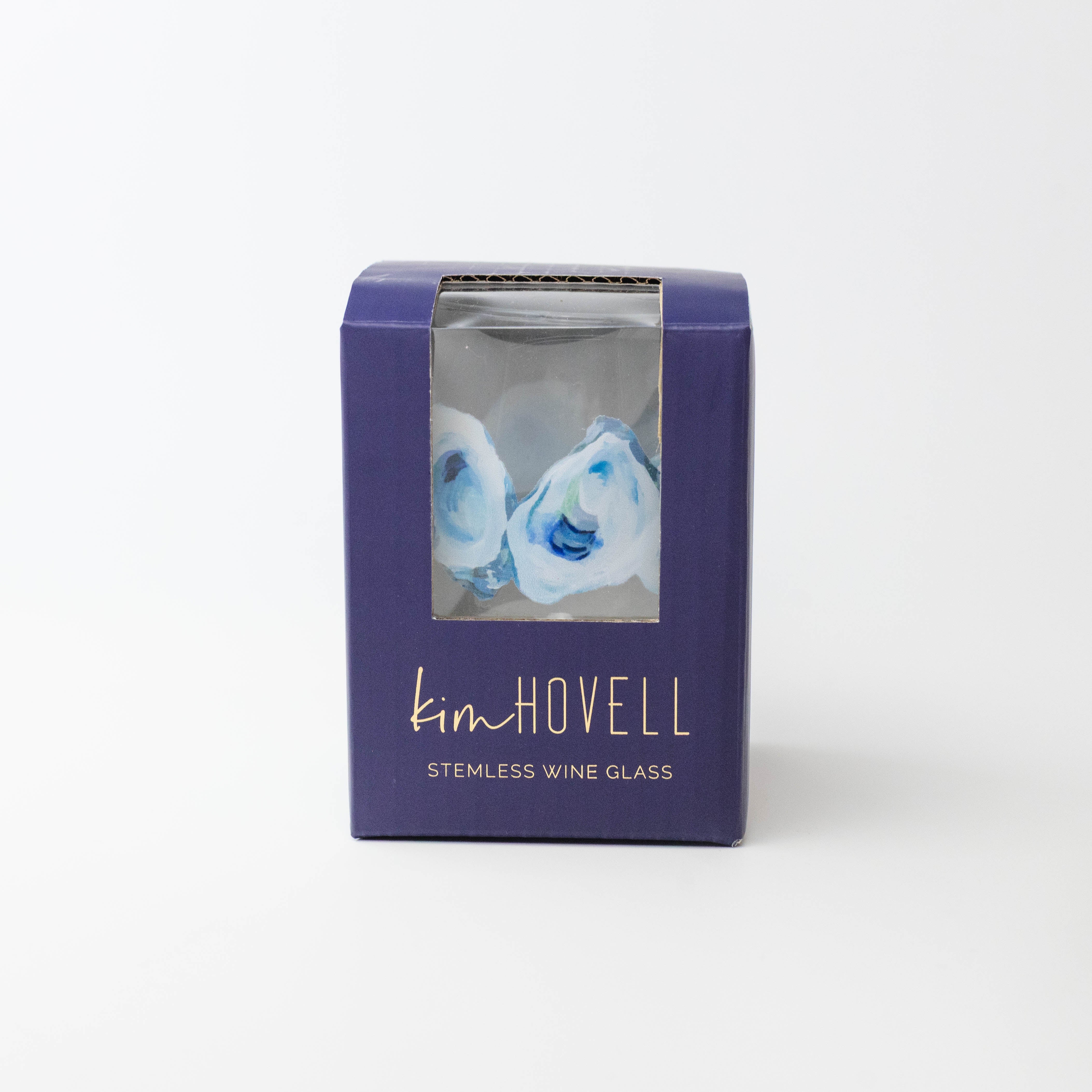 royal blue box with a clear window containing blue stemless oyster pattern wine glasses, branded 'kim Hovell'.
