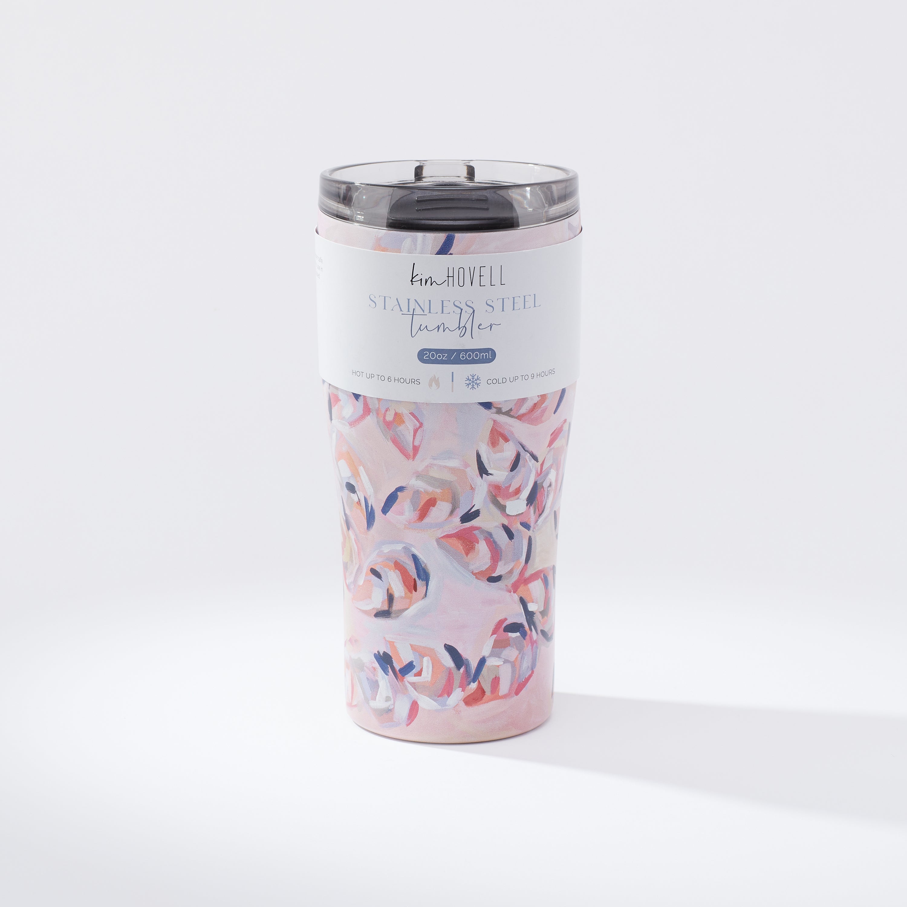 Kim Hovell Peach Gems pink shell-patterned 16oz coffee tumbler with product info sleeve around cup.