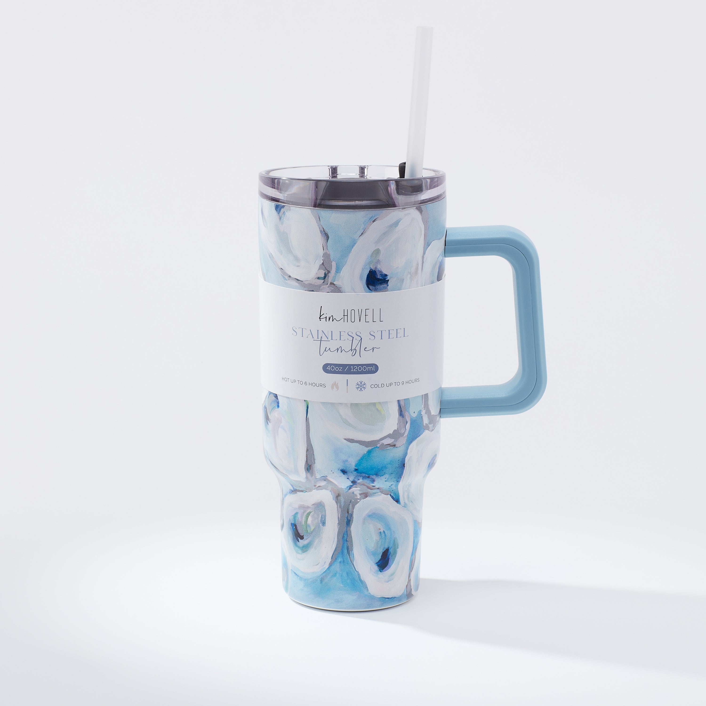 A blue and white oyster pattern 40oz tumbler with a handle and a straw, against a white background. Around tumbler features a package info sleeve. 