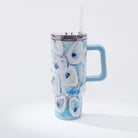 A blue and white oyster pattern 40oz tumbler with a handle and a straw, against a white background.