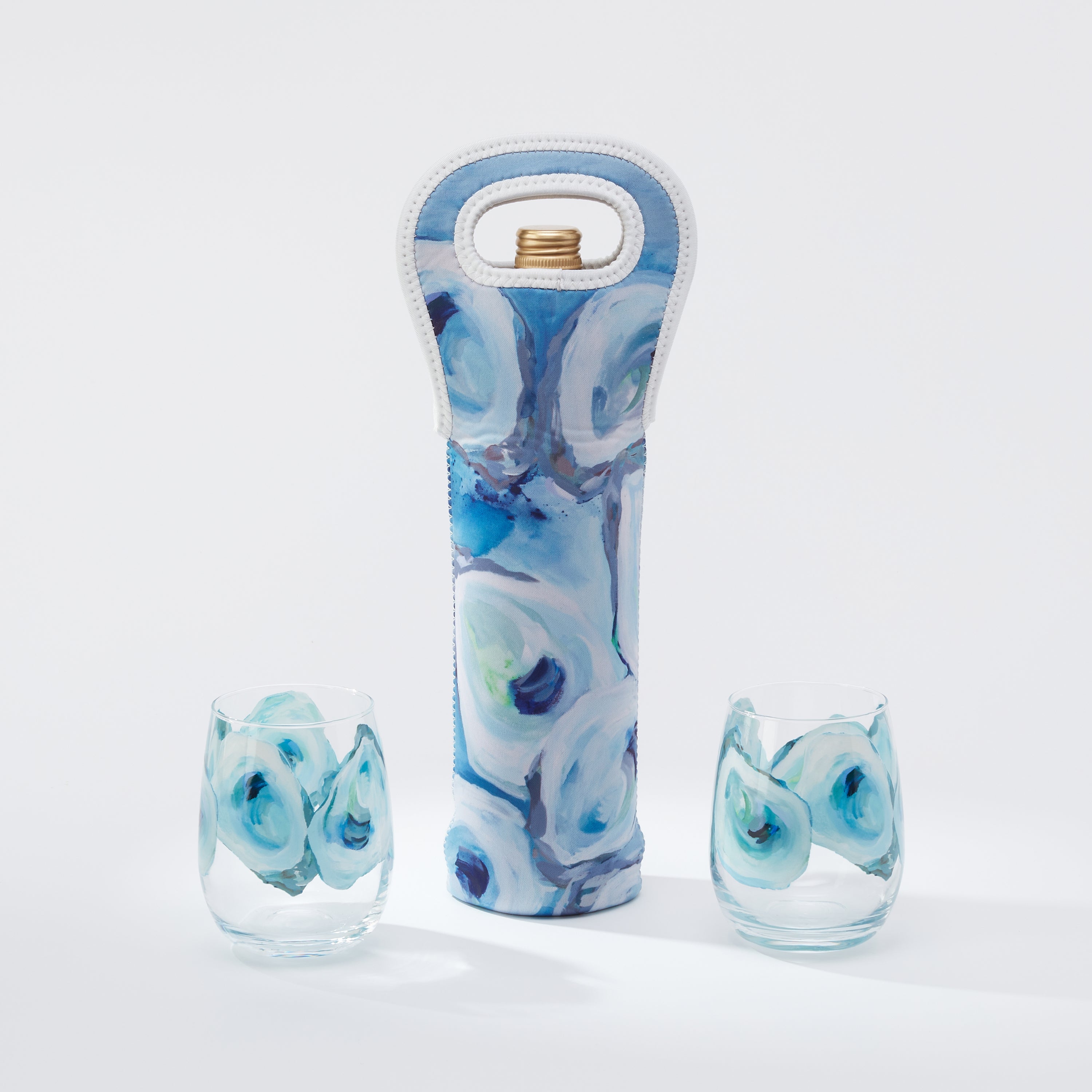 Kim Hovell Ebb and Flow wine tote with matching stemless glassware featuring blue and white oyster pattern. 