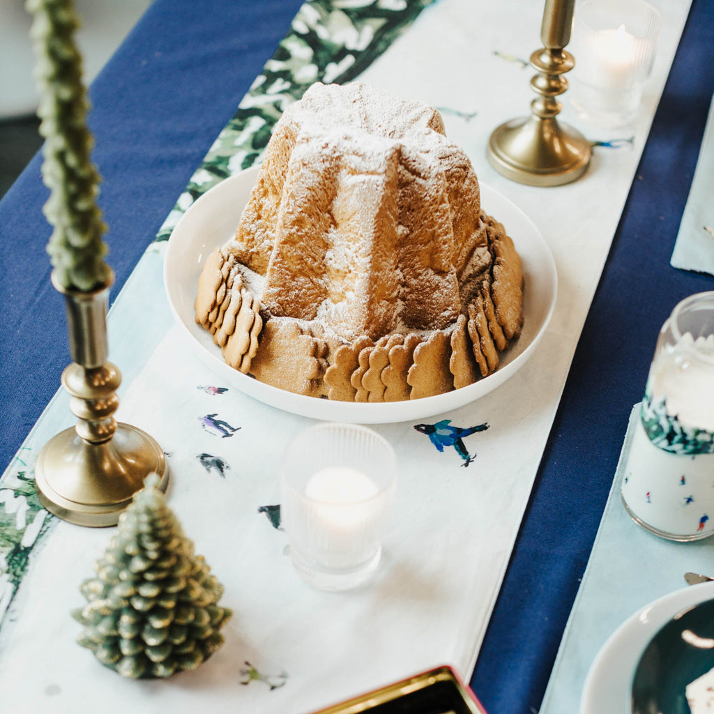 Bundt cake on a table with decorative ski elements.