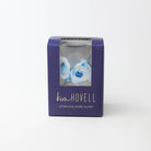 royal blue box with a clear window containing blue stemless oyster pattern wine glasses, branded 'kim Hovell'.