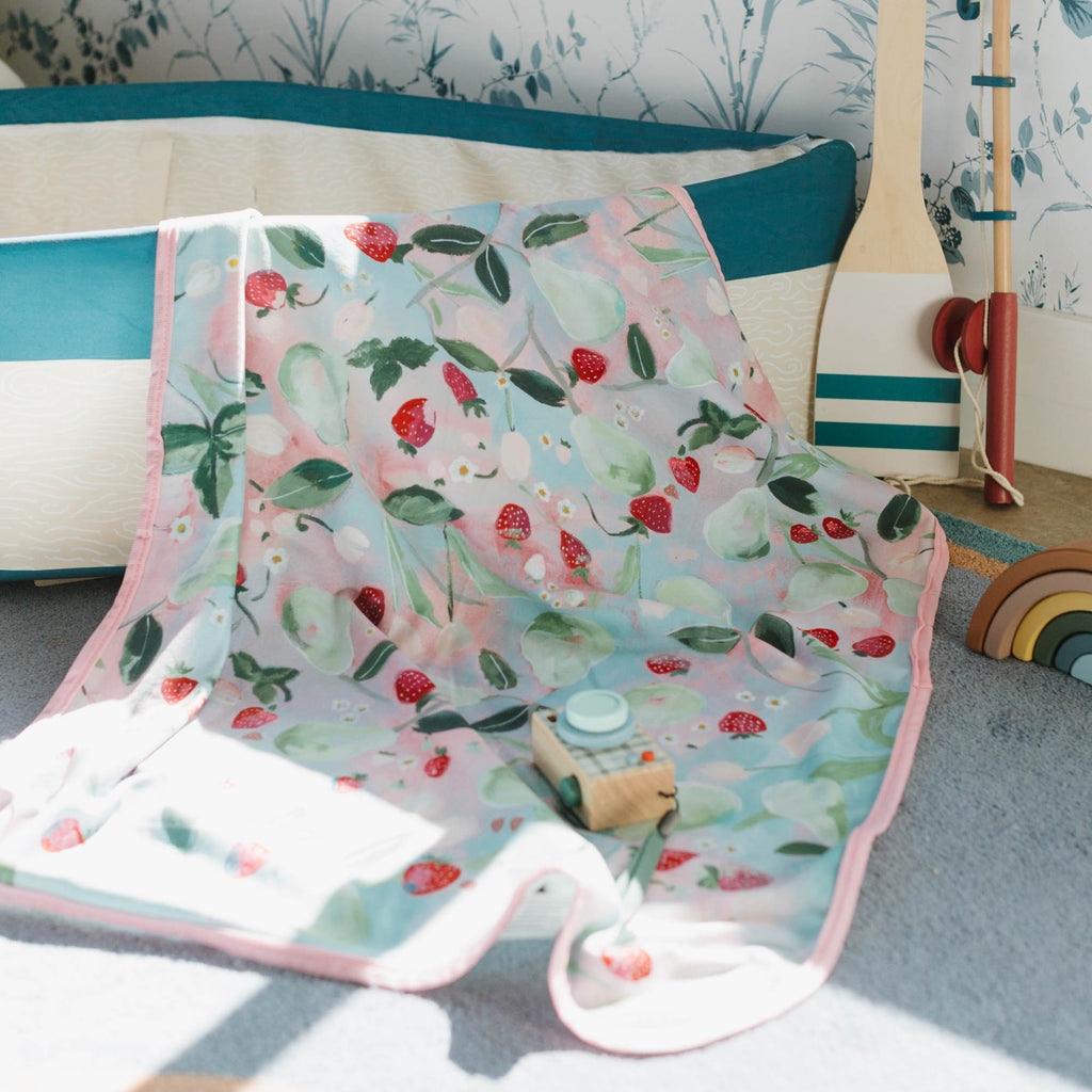 Kim Hovell Field and Vine fruit-patterned baby blanket in children's play room