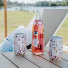 Two Kim Hovell peach gems shell-patterned wine tumblers with a bottle of strawberry lemonade on an outdoor wooden table 