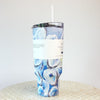 A video of a rotating blue and white oyster pattern 40oz tumbler with a handle and a straw, against a white background.